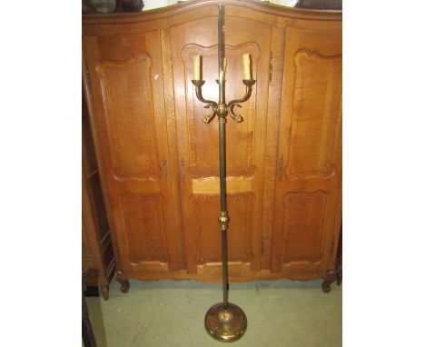 A cast brass three branch standard lamp with stylised dolphin, reeded column and weighted disc shaped platform base