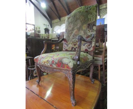 A late 19th century continental open armchair with floral tapestry upholstered seat and arched back, low down swept carved ar
