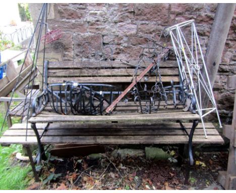A two seat garden bench with weathered timber lathes and cast iron supports, a folding bench seat, two small contemporary gar
