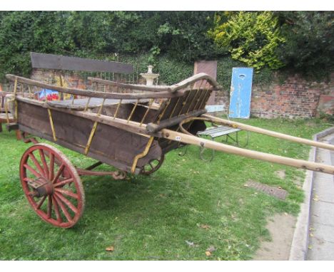 A local family owned old traditional pony trap, the wooden body with chamfered detail, iron fittings,bench seat and painted s