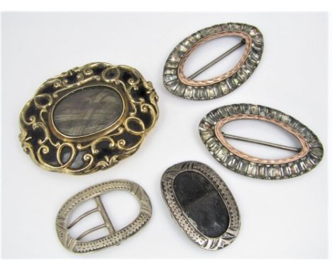 A mourning brooch/pendant with black enamel ground and scrolling decoration, encasing woven hair under glass and with inscrip