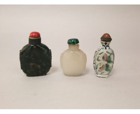 Three Chinese snuff bottles, two in jade and one in ceramic (3)