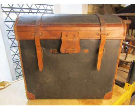 A vintage fibre and leather bound domed top travelling trunk, with basket lining and brass lock plate, printed stamp Malles L