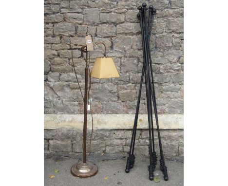 A contemporary telescopic and adjustable standard lamp with parchment tapered shade and domed disc shaped platform base, toge