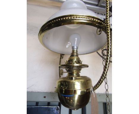 A Victorian brass hanging ceiling light with rope twist frame supporting a drop-in font and domed milk glass shade (originall