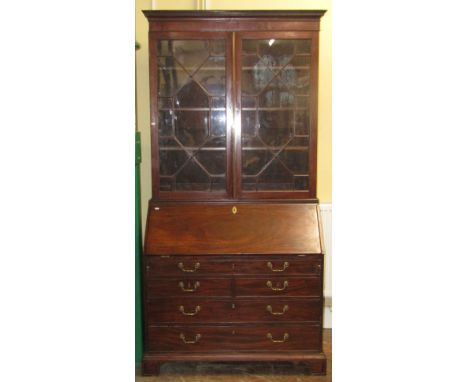 A substantial good quality Georgian mahogany bureau bookcase, the lower section enclosed by a arrangement of three long and t