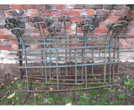 Four sections of reclaimed iron work railing with bow fronted outline, horizontal rails, scrolled finials and green painted f