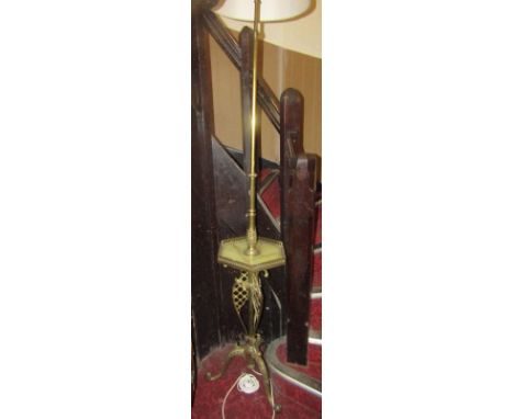 A gilded brass telescopic lamp standard supporting a hexagonal onyx tray raised on a tripod base, together with two others of