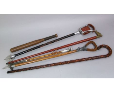 Mixed collection of walking sticks to include a cane, a further Malacca shafted stick with brass horse head handle, two shoot