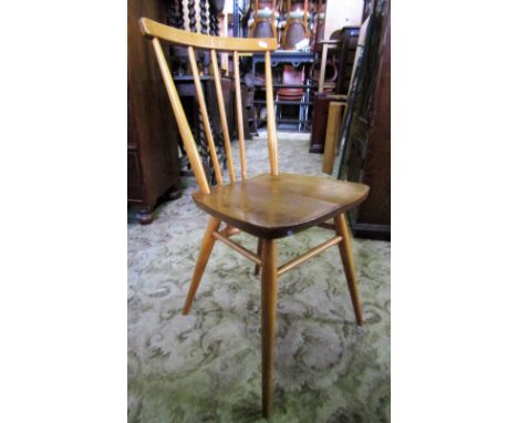 A set of four vintage Ercol light elm and beechwood stickback dining chairs with solid seats and tapered splayed supports