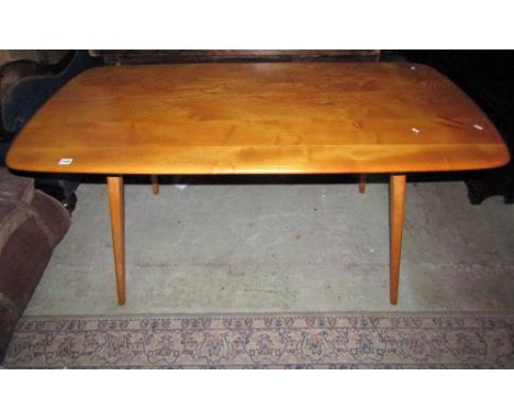 A vintage Ercol light elm and beechwood kitchen table of rectangular form with moulded outline raised on square tapered and s