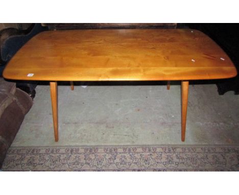 A vintage Ercol light elm and beechwood kitchen table of rectangular form with moulded outline raised on square tapered and s