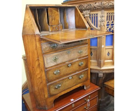 An unusual Queen Anne style corner bureau, the fall flap revealing a fitted interior of a drawer, cupboard and pigeon hole ov