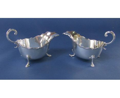 A pair Edwardian silver sauce boats, with pie crust rim, S scroll handle and cabriole hoof feet, maker Henry Wilkinson &amp; 