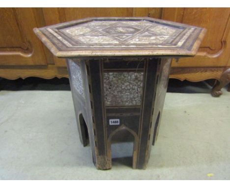 An eastern Moorish ebonised mother of pearl inlaid sewing table of hexagonal form with hinged lid and lined interior