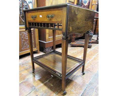 An Edwardian rosewood drop leaf side table, enclosing a frieze drawer over an open gallery, raised on square cut and tapering