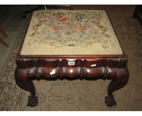 A Georgian style dressing stool of rectangular form with drop in tapestry seat, moulded outline and claw and ball supports