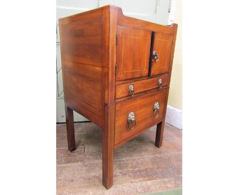 A Georgian mahogany tray top commode, the front elevation enclosed by a pair of cupboard doors, frieze drawer and commode fro