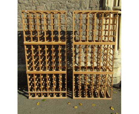 A pair of contemporary light oak wine racks with slatted frames, each to hold ninety bottles