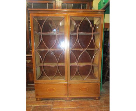 A Georgian mahogany display cabinet, the three quarter length glazed panel doors with over form glazing bars, enclosing three