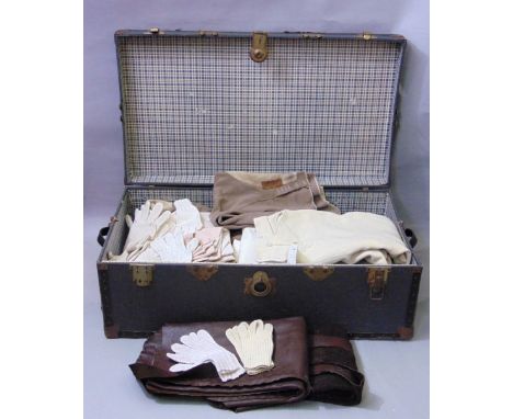 A large travelling trunk containing nineteen pairs of vintage jodhpurs (various periods), ten pairs of riding gloves and two 