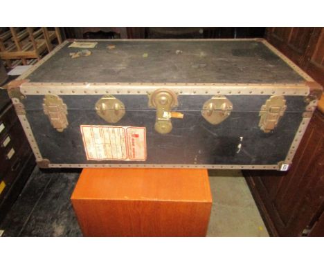 A Victorian dome top tin trunk with banded detail and simulated wood grain finish, one other housed within and a vintage cabi