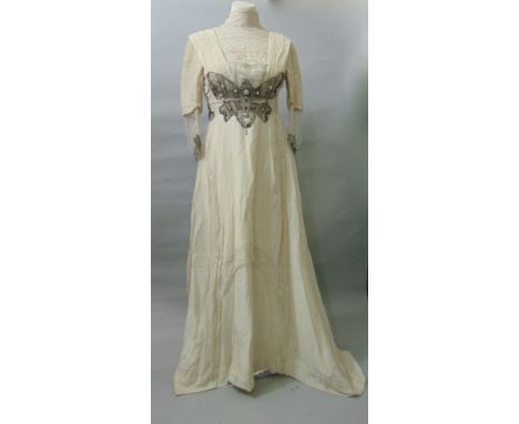 An Edwardian cream dress with butterfly decoration, a further two piece Edwardian dress in light blue together with a full le