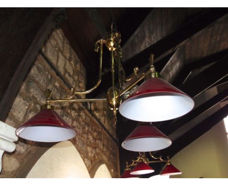 A pair of Edwardian style three branch overhead light fittings with conical shaped ruby glass shades