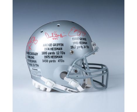 An Ohio State helmet celebrating their three Heisman Trophy winners, Howard Cassidy, Archie Griffin, and Eddie George, along 