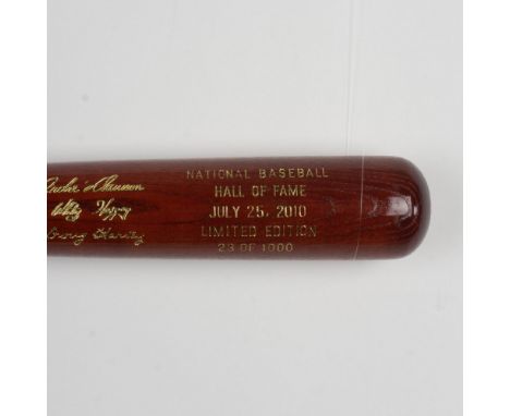 A beautiful, limited edition brown bat with gold etched logos and signatures of inductees, Andre Dawson, Doug Harvey, and Whi