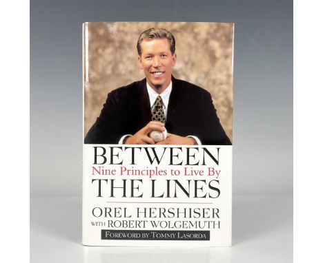 Between the Lines: Nine Principles to Live By, a hardcover book with original dustcover and 172 pages. Autographed by Orel He