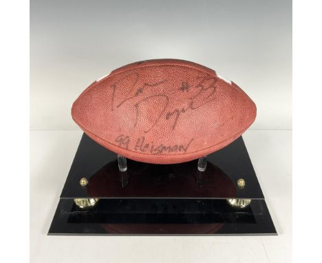 A football signed by Ron Dayne in black ink, featuring striking white and gold-colored accents. Wilson backstamp. Wilson manu