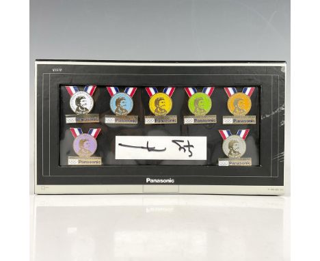 This pin set commemorates the seven gold medals won by Mark Spitz during the 1972 games along with trading cards and an autog
