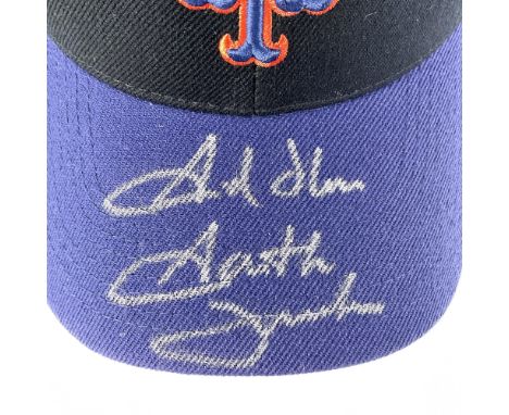 This hat features a black top with a blue brim, embroidered NY Mets logo on the front, and an adjustable snap back. It is sig