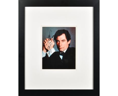 James Bond 007 - TIMOTHY DALTON - signed photo, signed photograph of the actor with gun in costume of James Bond, signed in b
