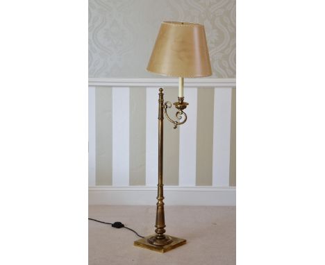 An antiqued brass reading lamp, modern, with vellum style shade, overall height 55in. (140cm.).