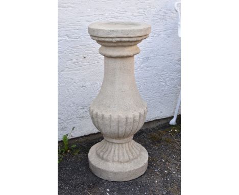 A composite stone sundial pedestal of half gadrooned baluster form, 30in. (76.2cm.) high, no sundial.