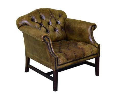 A Chesterfield style leather button back tub armchair, second half 20th century, in worn olive green leather, 32in. (81.25cm.