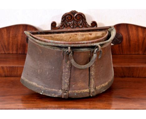 A 19th century copper and wrought iron demi-lune wall planter hanging loops to rear, single handle to front, with later coppe