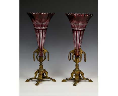 A pair of 19th century ruby cased glass and gilt metal vases the trumpet vases with cut barbed rims and panel and comb cut de