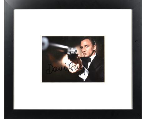 James Bond 007 - DANIEL CRAIG - signed photo, signed photograph of the actor with gun in costume of James Bond, signed in bla