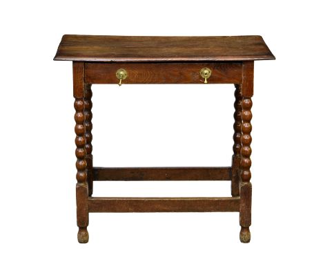 A late 17th / early 18th century joined oak single drawer side table,&nbsp;the two plank top with chamfered edge, over a sing
