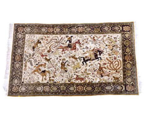 An Indian silk hunting rug,&nbsp;third quarter 20th century, the buff field with figures on horseback and dogs hunting&nbsp;s