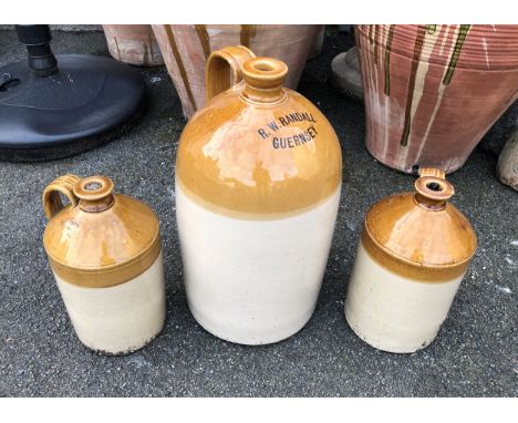 A large R. W. Randall Guernsey stoneware 4 gallon flagon 19½in. high; together with two smaller unmarked flagons, one impress