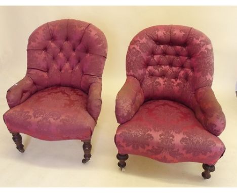 Two similar Victorian red button upholstered armchairs on turned supports