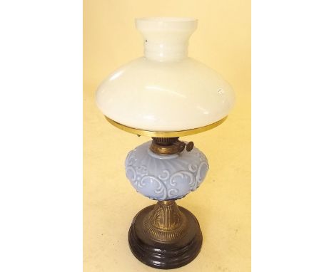 A Victorian oil lamp with blue moulded glass reservoir