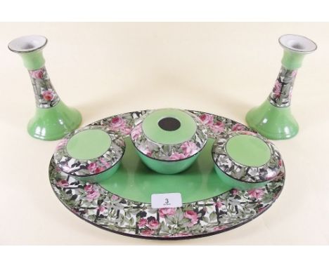 A Wilkinson floral printed dressing table set comprising two candlesticks, three dressing table pots and tray decorated roses