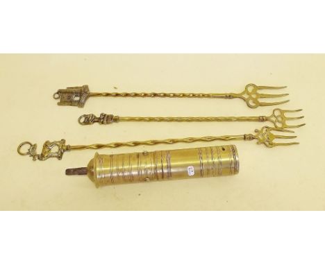 A brass Arabic coffee grinder and three toasting forks