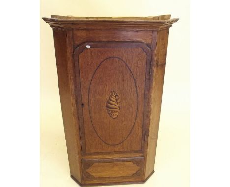 A small oak corner cupboard with shell to door (made from longcase clock)