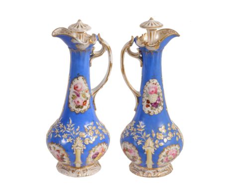 A pair of Staffordshire porcelain 'Rococo revival' ewers and stoppers  A pair of Staffordshire porcelain 'Rococo revival' ewe